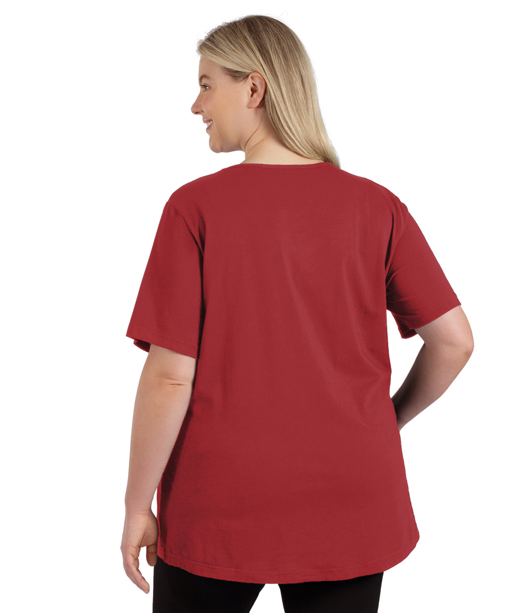 Plus size woman, facing to the back, wearing JunoActive plus size Stretch Naturals Lite Short Sleeve V-Neck Top in the color Rosy Red.   She is wearing JunoActive Plus Size Leggings in the color black. 
