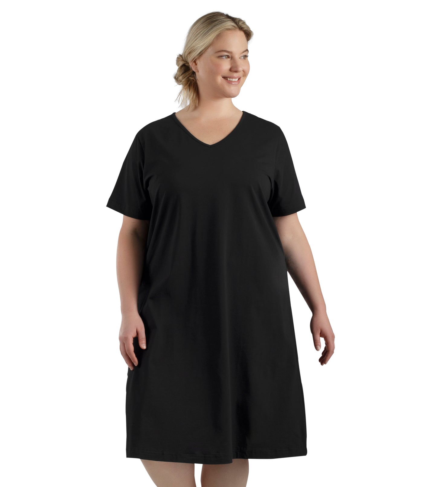 Plus size woman, facing front, wearing JunoActive plus size JunoBliss Sleep Dress in color black. The hem falls just below her knee.