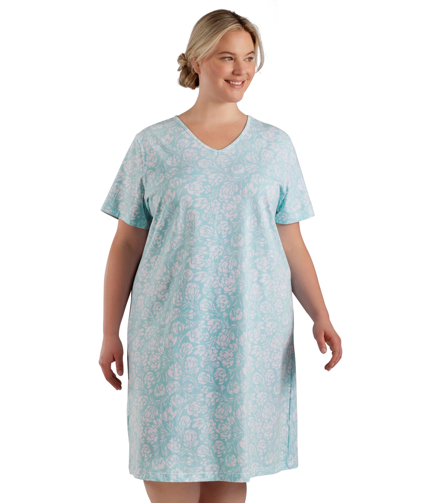 Plus size woman, facing front, wearing JunoActive plus size JunoBliss Sleep Dress in color Spring Blue Floral. The hem falls just below her knee.