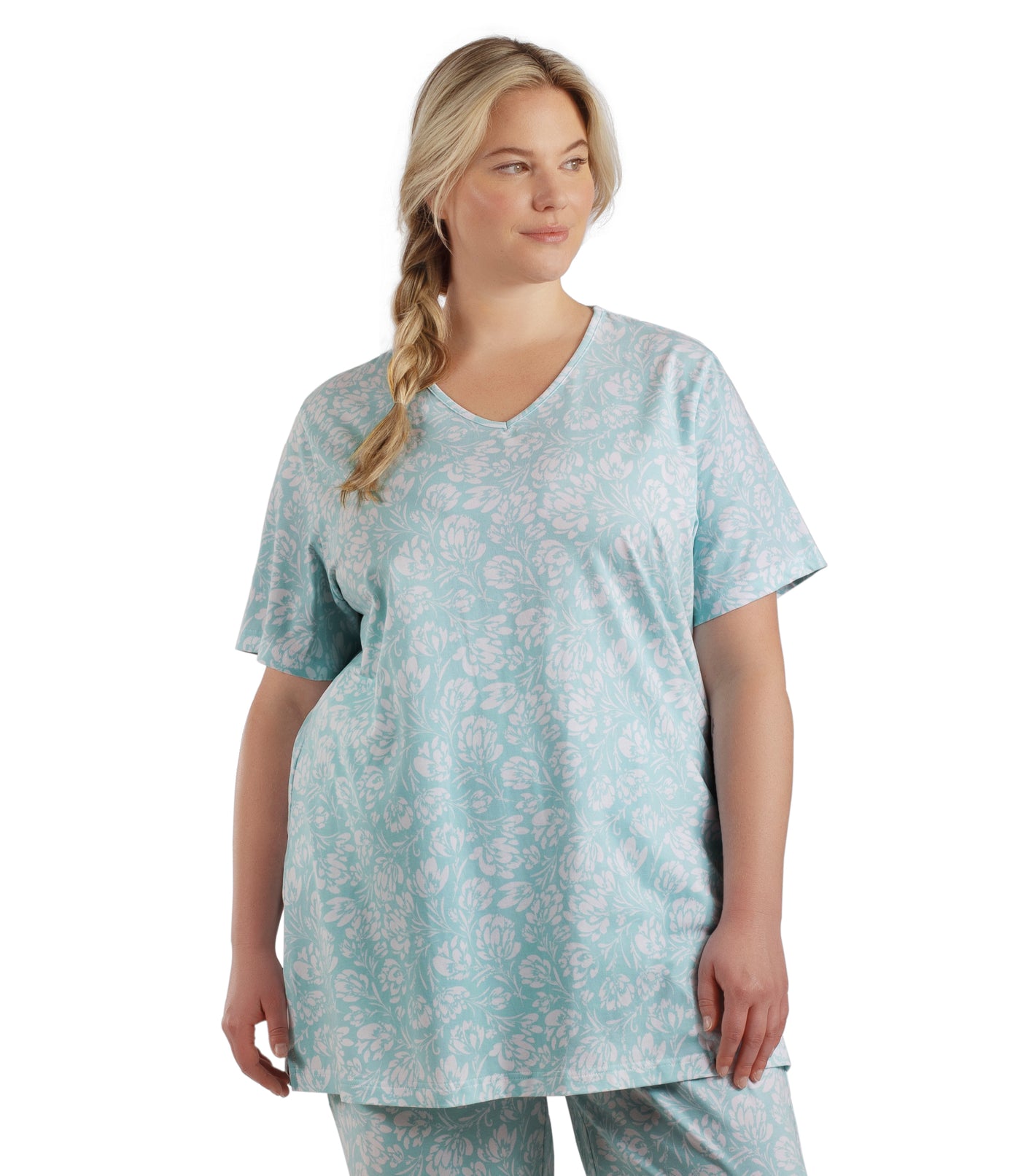 Plus size woman, facing front, wearing JunoActive plus size JunoBliss V-Neck Short Sleeve Sleep Top in color Spring Blue Floral Print. The woman is wearing a pair of JunoBliss Pocketed Sleep Pants in color Spring Blue Floral Print.