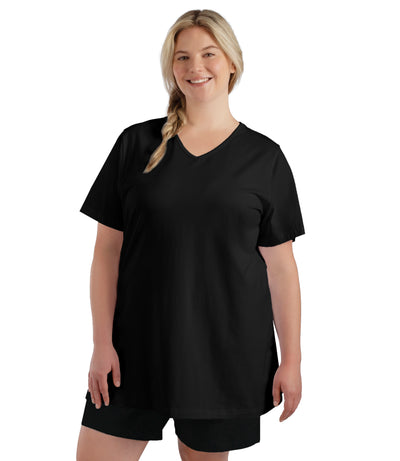 Plus size woman, facing front, wearing JunoBliss V-Neck Short Sleeve Top in color black. Hands down by sides.