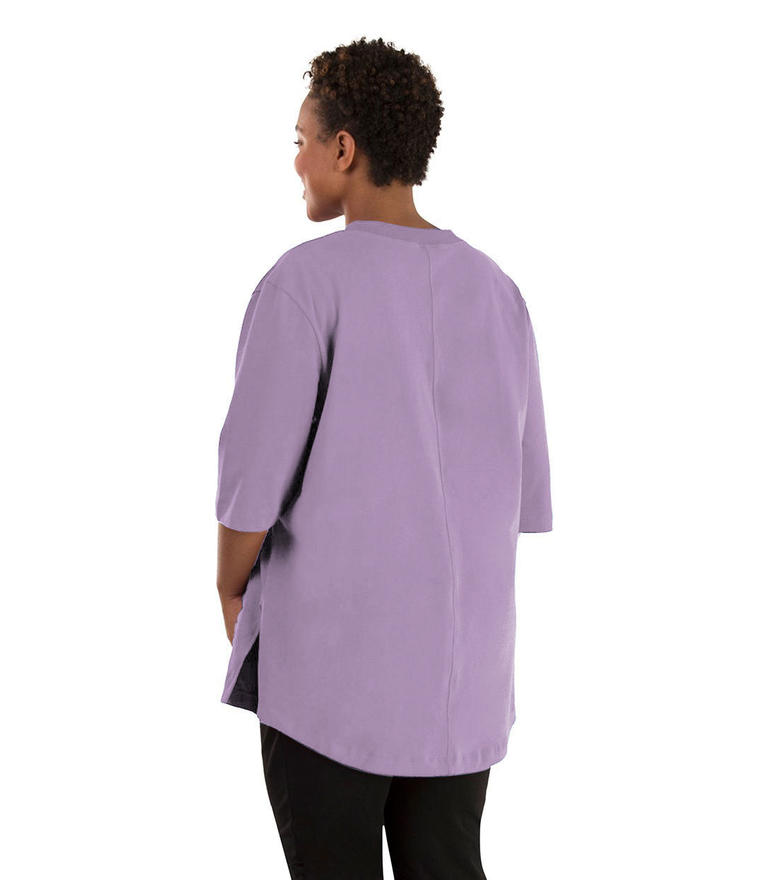 Plus size woman, facing back left, wearing JunoActive plus size Legacy Cotton Casual Tunic in the color Lavender. She is wearing JunoActive Plus Size Leggings in the color black.