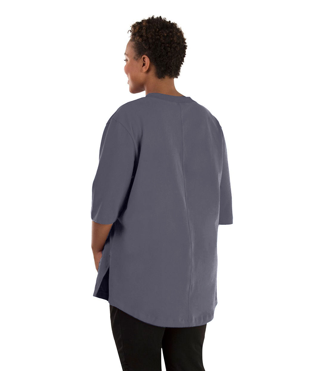 Plus size woman, facing back left, wearing JunoActive plus size Legacy Cotton Casual Tunic in the color Misty Grey. She is wearing JunoActive Plus Size Leggings in the color black.