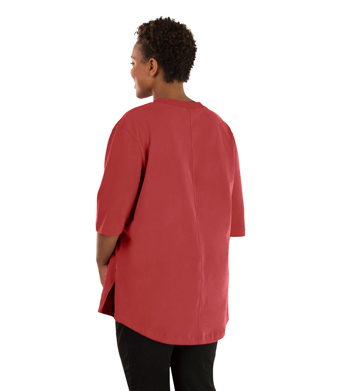 Plus size woman, facing back, wearing JunoActive plus size Legacy Cotton Casual Tunic in the color Sedona Red. She is wearing JunoActive Plus Size Leggings in the color black.