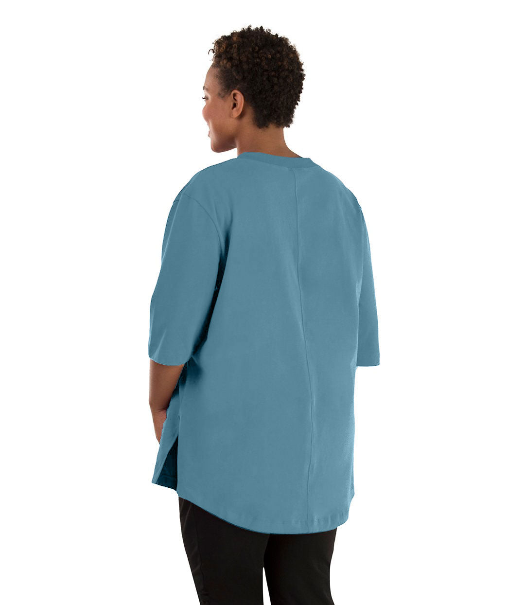 Plus size woman, facing back left, wearing JunoActive plus size Legacy Cotton Casual Tunic in the color Arctic Blue. She is wearing JunoActive Plus Size Leggings in the color black. 