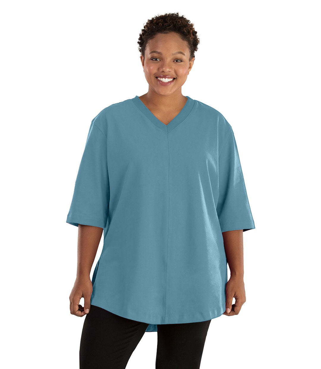 Plus size woman, facing front, wearing JunoActive plus size Legacy Cotton Casual Tunic in the color Arctic Blue. She is wearing JunoActive Plus Size Leggings in the color black. 