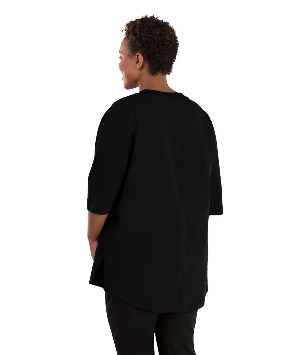 Plus size woman, facing back left, wearing JunoActive plus size Legacy Cotton Casual Tunic in the color  Black. She is wearing JunoActive Plus Size Leggings in the color black. 