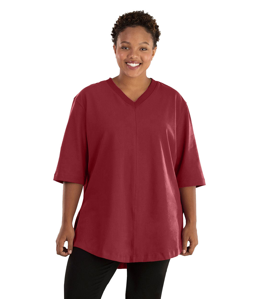 Plus size woman, facing front, wearing JunoActive plus size Legacy Cotton Casual Tunic in the color Garnet. She is wearing JunoActive Plus Size Leggings in the color black.