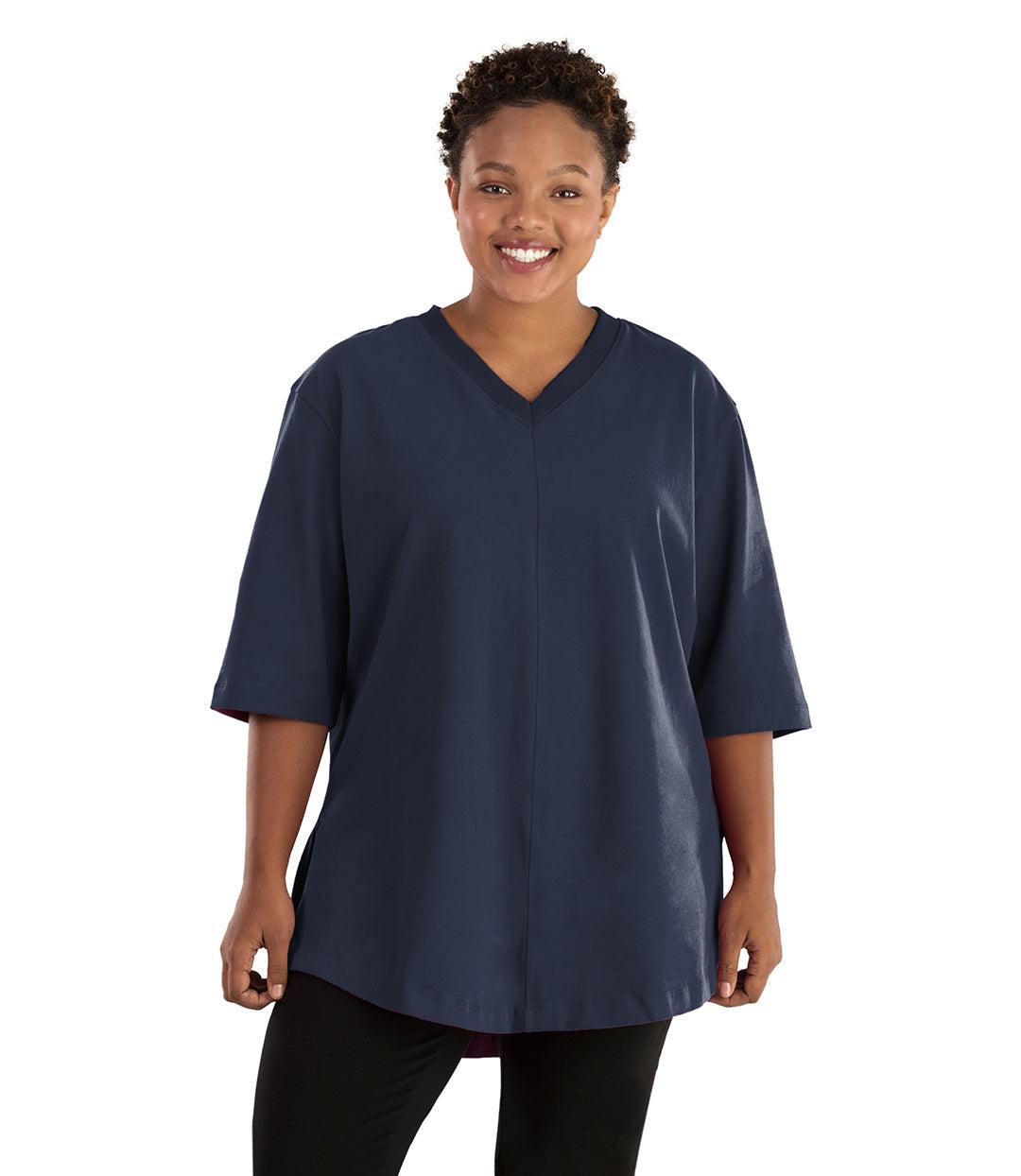 Plus size woman, facing front, wearing JunoActive plus size Legacy Cotton Casual Tunic in the color Navy. She is wearing JunoActive Plus Size Leggings in the color black. 