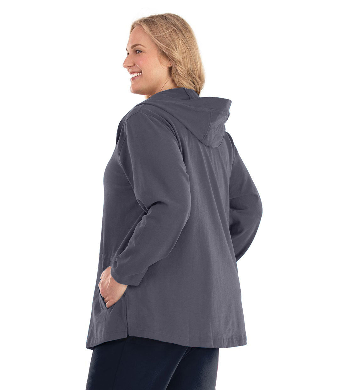 Plus size woman, facing back, wearing Legacy Cotton Casual Button Up Hoodie in Misty Grey. Both hands are in side pockets of hoodie.