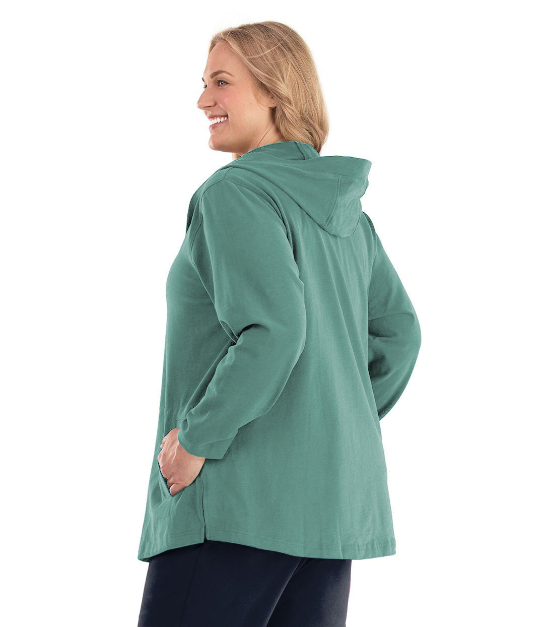 Plus size woman, facing back, wearing Legacy Cotton Casual Button Up Hoodie in Lichen Green. Both hands are in side pockets of hoodie.