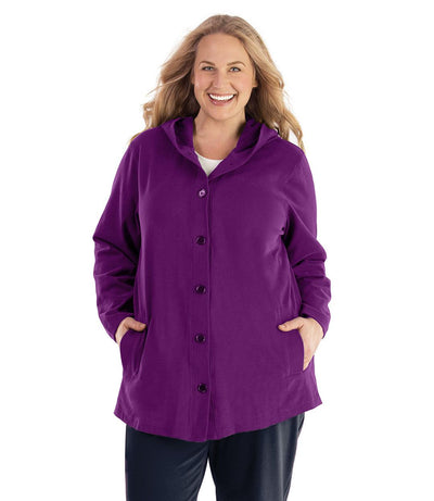 Plus size woman, facing front, wearing JunoActive plus size Legacy Cotton Casual Button Up Hoodie in the color Heliotrope Purple. She is wearing JunoActive Plus Size Leggings in the color Black.