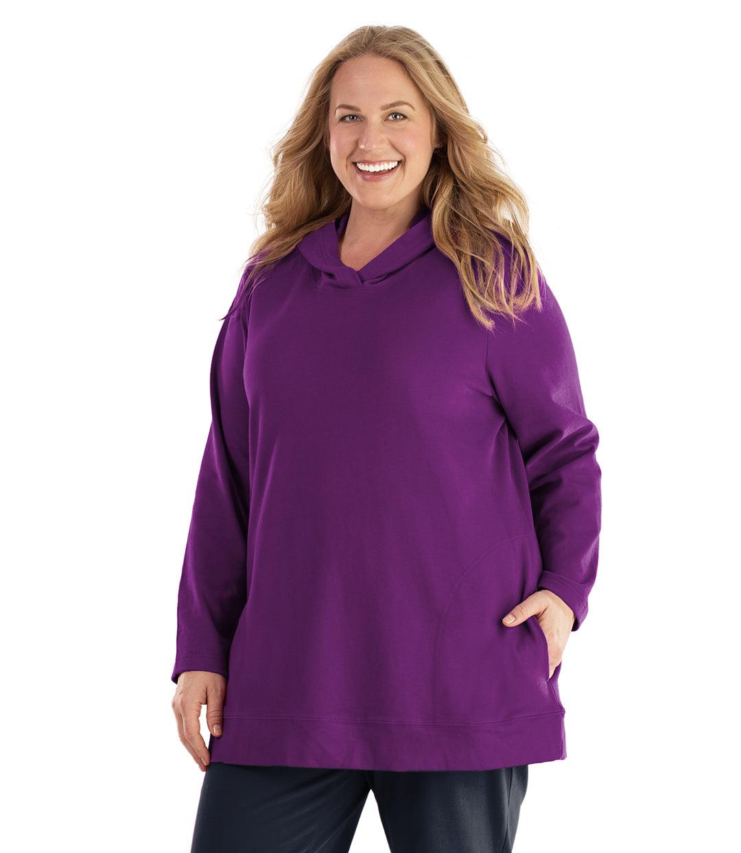 Plus size woman, facing front, wearing JunoActive plus size Legacy Cotton Casual Pullover Hoodie in the color Heliotrope Purple. She is wearing JunoActive Plus Size Leggings in the color Navy.
