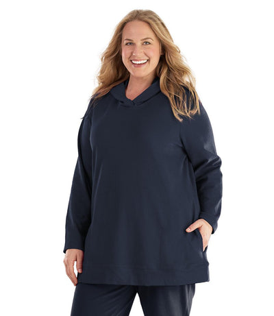 Plus size woman, facing front, wearing JunoActive plus size Legacy Cotton Casual Pullover Hoodie in the color Navy. She is wearing JunoActive Plus Size Leggings in the color Navy.