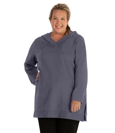 Plus size woman, facing front, wearing JunoActive plus size Legacy Cotton Casual Pullover V-Neck Hoodie in the color Misty Grey. She is wearing JunoActive Plus Size Leggings in the color Black.