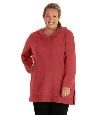 Plus size woman, facing front, wearing JunoActive plus size Legacy Cotton Casual Pullover V-Neck Hoodie in the color Sedona Red. She is wearing JunoActive Plus Size Leggings in the color Black.