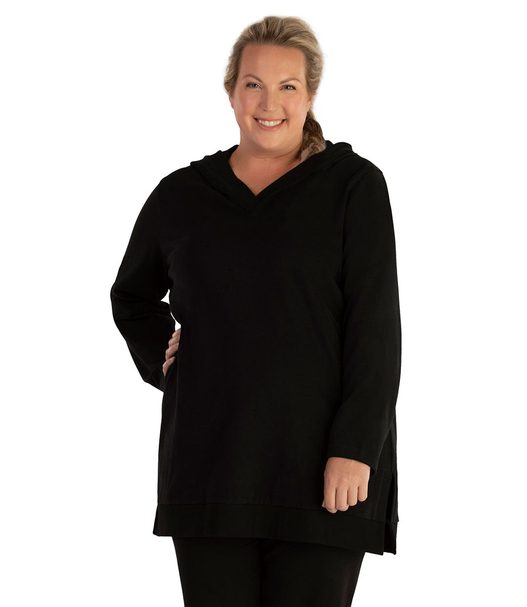 Plus size woman, facing front, wearing JunoActive plus size Legacy Cotton Casual Pullover V-Neck Hoodie in the color Black. She is wearing JunoActive Plus Size Leggings in the color Black.