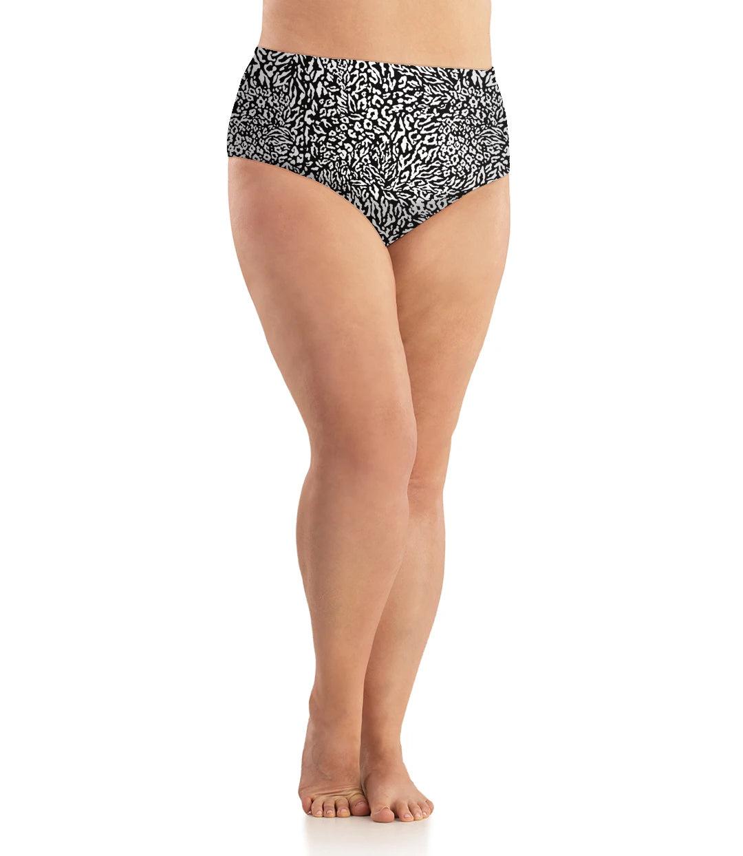 Bottom half of plus sized woman, facing front, wearing JunoActive Junowear Cotton Stretch Classic Brief in wild print. This brief fits to the waistline with conservative leg opening. Wild print is a black print with white animal spots.