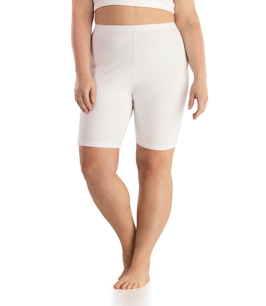 Bottom half of plus sized woman, front view, wearing JunoActive Stretch Naturals Bike Shorts in color white. Bottom hem is a few inches above the knee. 