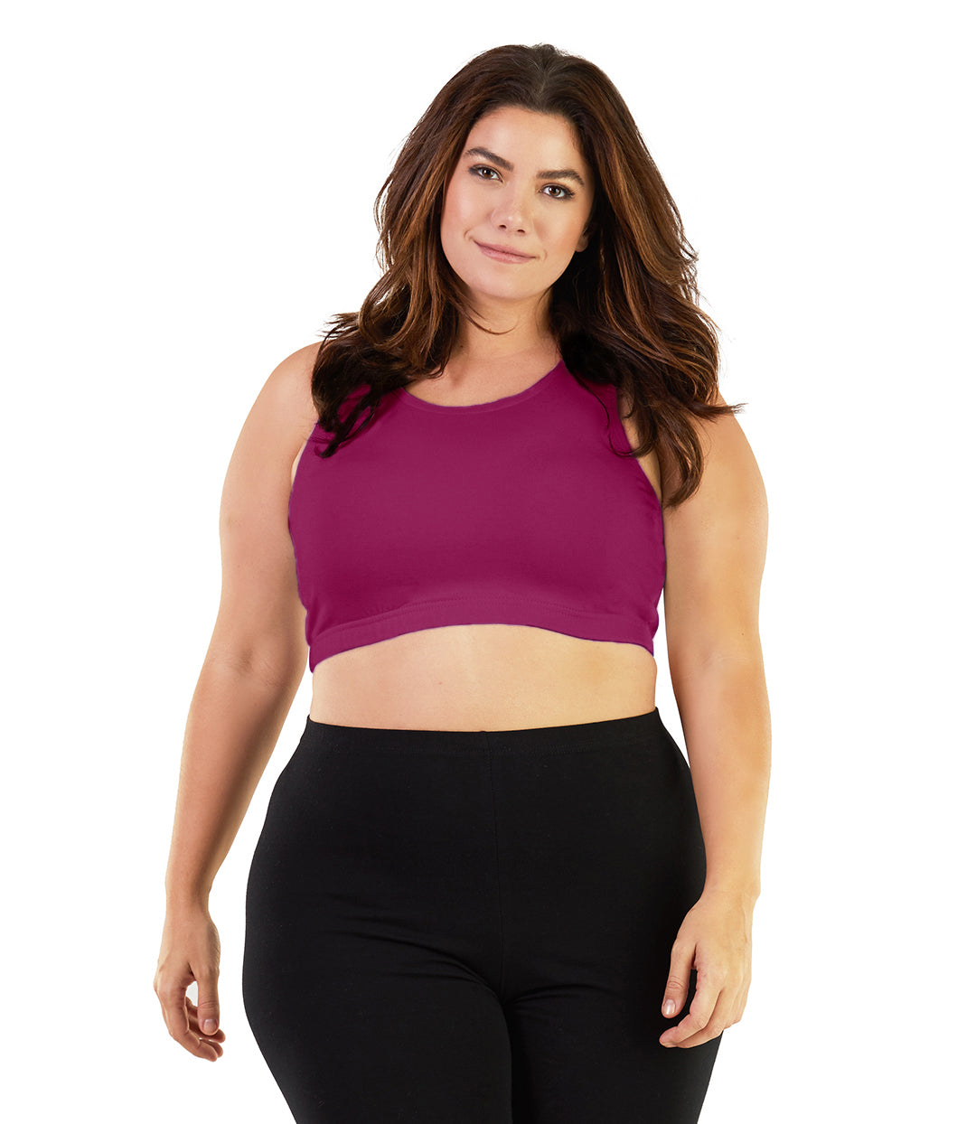 Plus size woman, facing front, wearing JunoActive plus size Stretch Naturals Scoop Neck Bra in Merlot. The woman is wearing black plus size JunoActive leggings. Her arms fall naturally to her side.