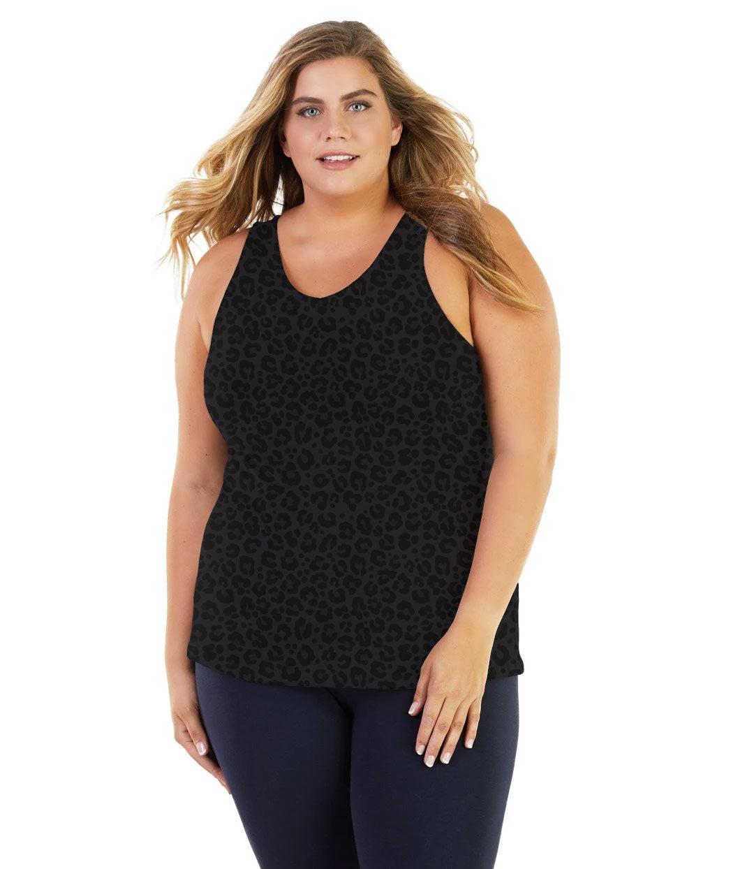 Plus size woman, facing front, wearing JunoActive plus size Stretch Naturals Tank in Deep Leopard Print. The woman is wearing a pair of Navy Blue JunoActive leggings. 