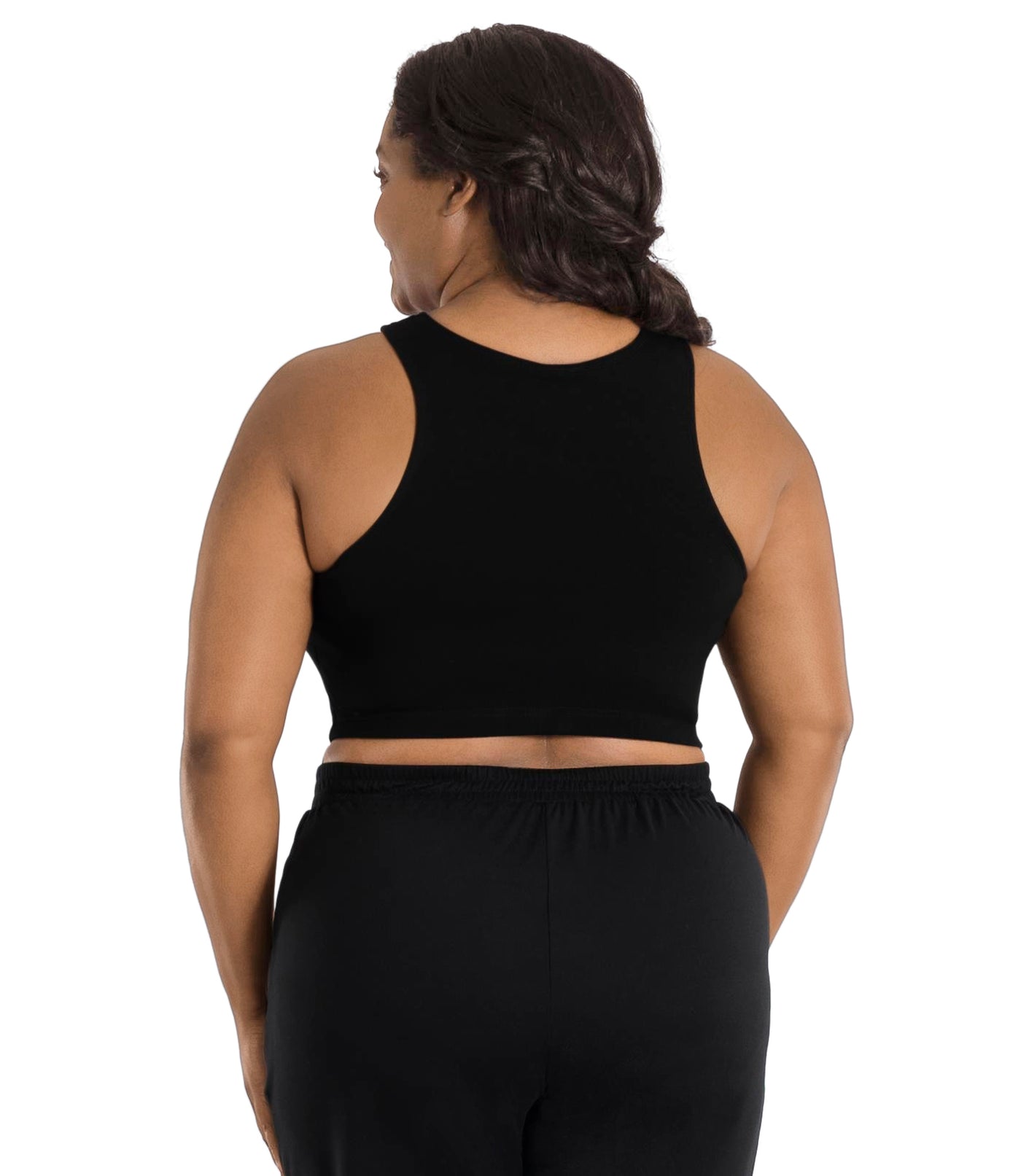 A plus size woman, facing back, wearing a black JunoActive Stretch naturals full fit plus size bra. Featuring a v-neck and side bust darts for a full fit. She is also wearing black JunoActive plus size pants.