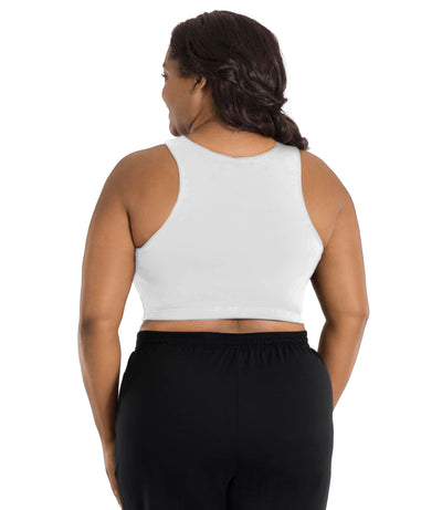 A plus size woman, facing back, wearing a white JunoActive Stretch naturals full fit plus size bra. Featuring a v-neck and side bust darts for a full fit. She is also wearing black JunoActive plus size pants.