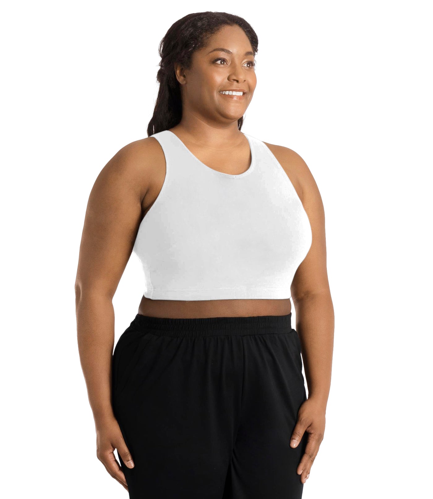 Front view of a plus size woman wearing a white JunoActive Stretch naturals full fit plus size bra. Featuring a v-neck and side bust darts for a full fit. She is also wearing black JunoActive plus size pants.