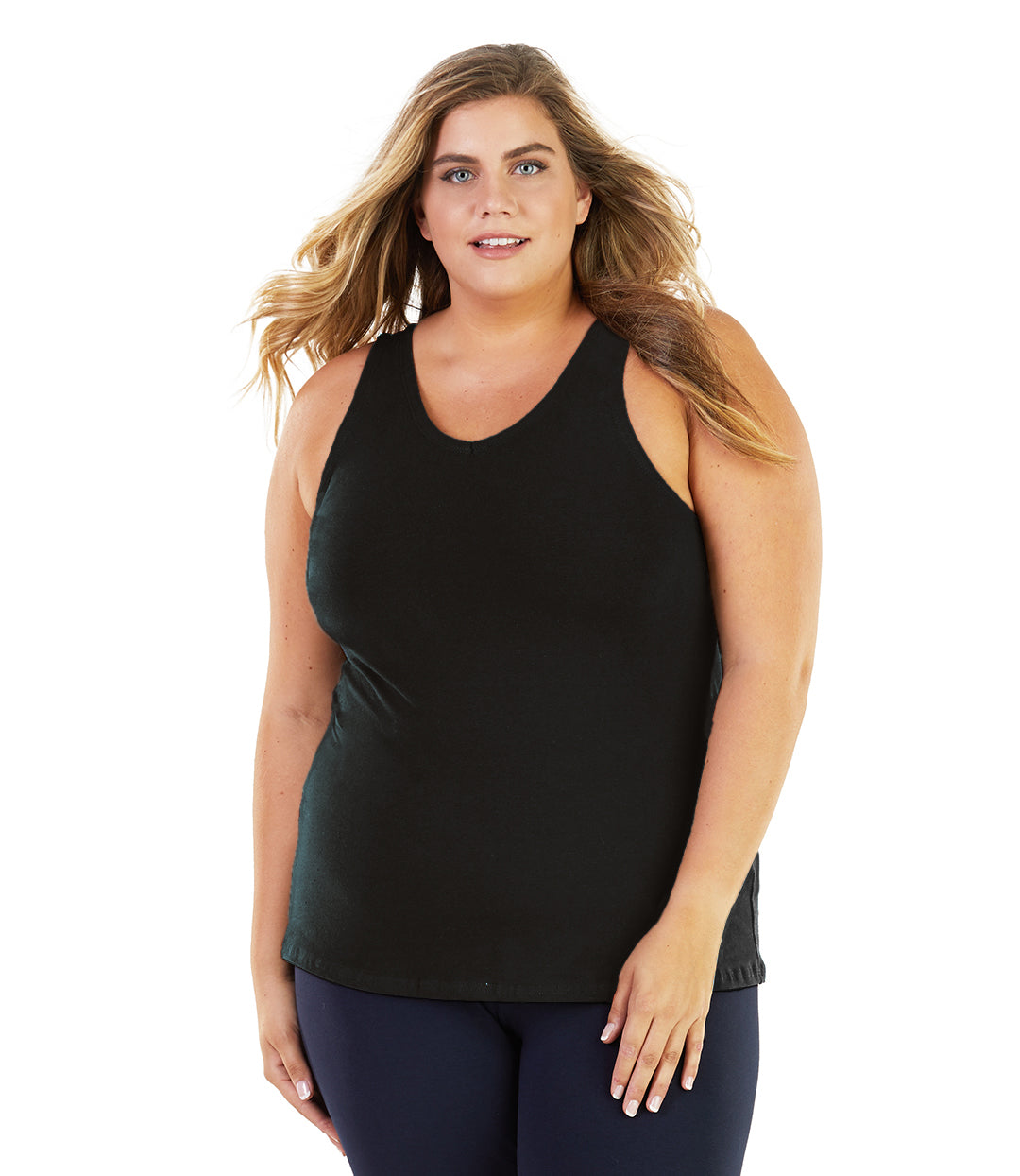 Plus size model, facing front, wearing Stretch Naturals V-Neck Tank in Black. Arms fall naturally by her side. She is also wearing JunoActive plus-size leggings in navy.