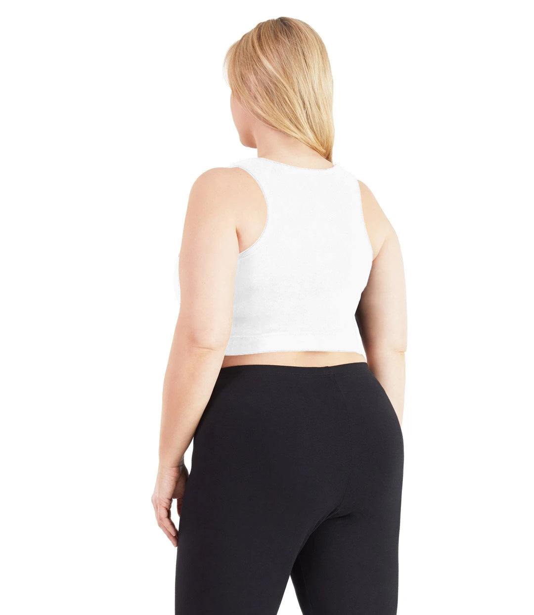 Plus size woman, facing back, wearing JunoActive plus size Stretch Naturals V-Neck Bra top in white. The woman is wearing black JunoActive plus size leggings. Her arms fall naturally to her side.