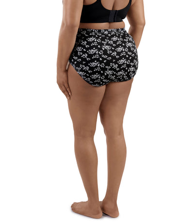 Plus-size Model wearing JunoActive's Junowear Cotton Stretch Classic Full Fit Brief in Fresh Gardenia Print. Model facing back.