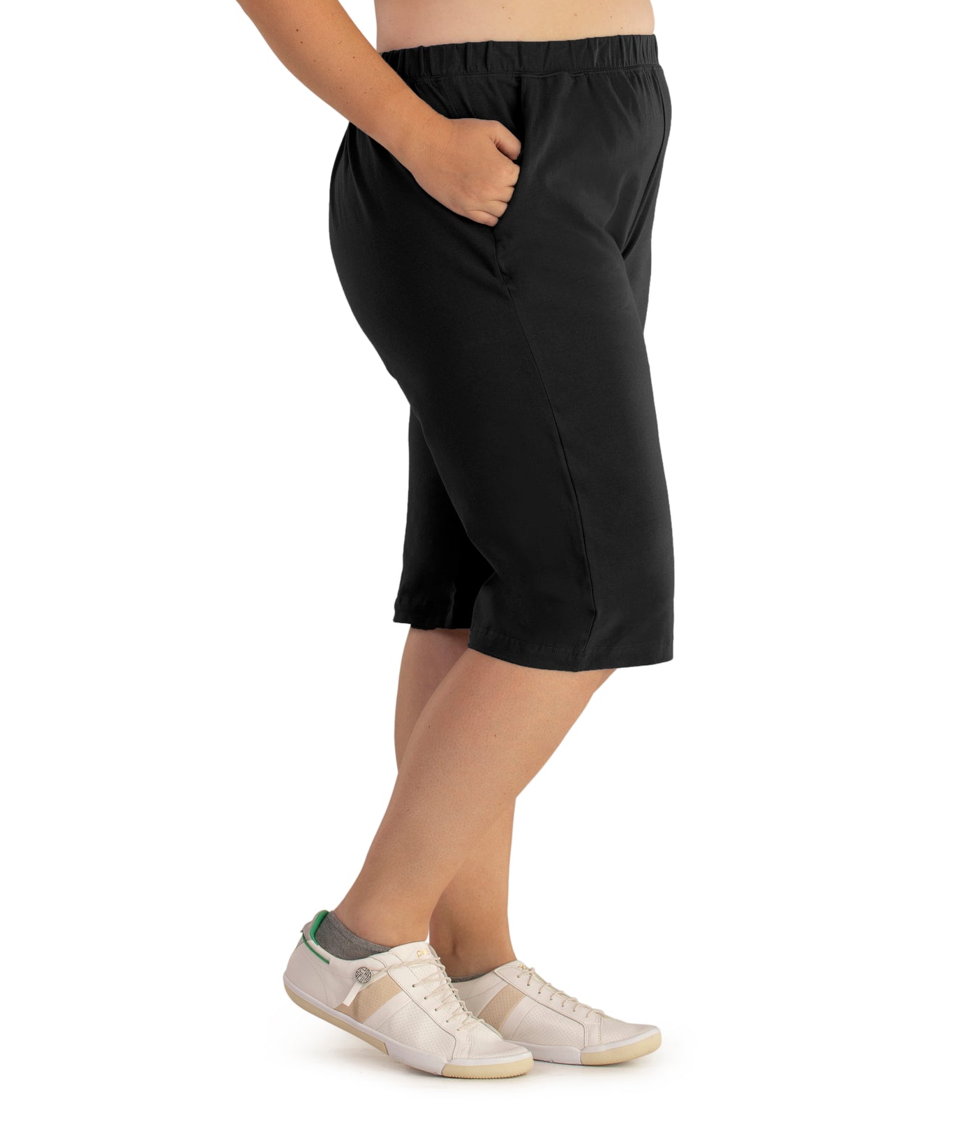 Bottom half of plus sized woman, side view, wearing JunoActive Stretch Naturals Bermuda Shorts in color black. Bottom hem is at the knee.