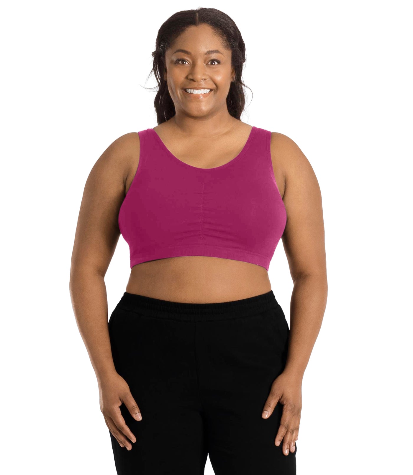 Plus size woman, facing front, wearing JunoActive Stretch Naturals Shirred Bra Top. Bra is gathered in middle and is a scoop top neck. Straps are wide and bra color is merlot.