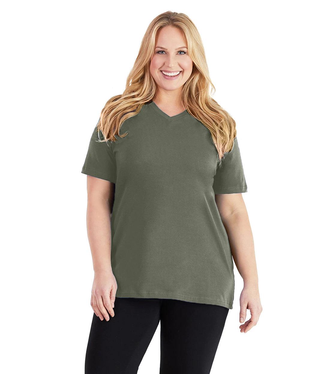 Plus size woman, facing front, wearing JunoActive plus size Stretch Naturals V-Neck in the color Moss Green. She is wearing JunoActive Plus Size Leggings in the color black.