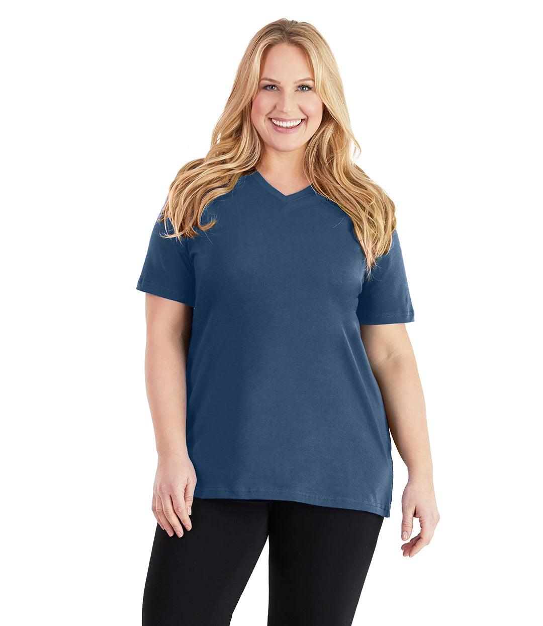 Plus size woman, facing front, wearing JunoActive plus size Stretch Naturals V-Neck in the color Denim Blue. She is wearing JunoActive Plus Size Leggings in the color black. 