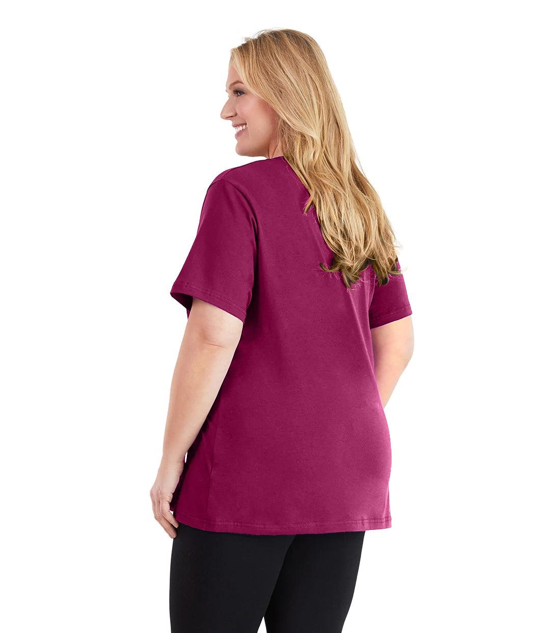 Plus size woman, facing back and looking left, wearing JunoActive plus size Stretch Naturals V-Neck in the color Merlot. She is wearing JunoActive Plus Size Leggings in the color black.