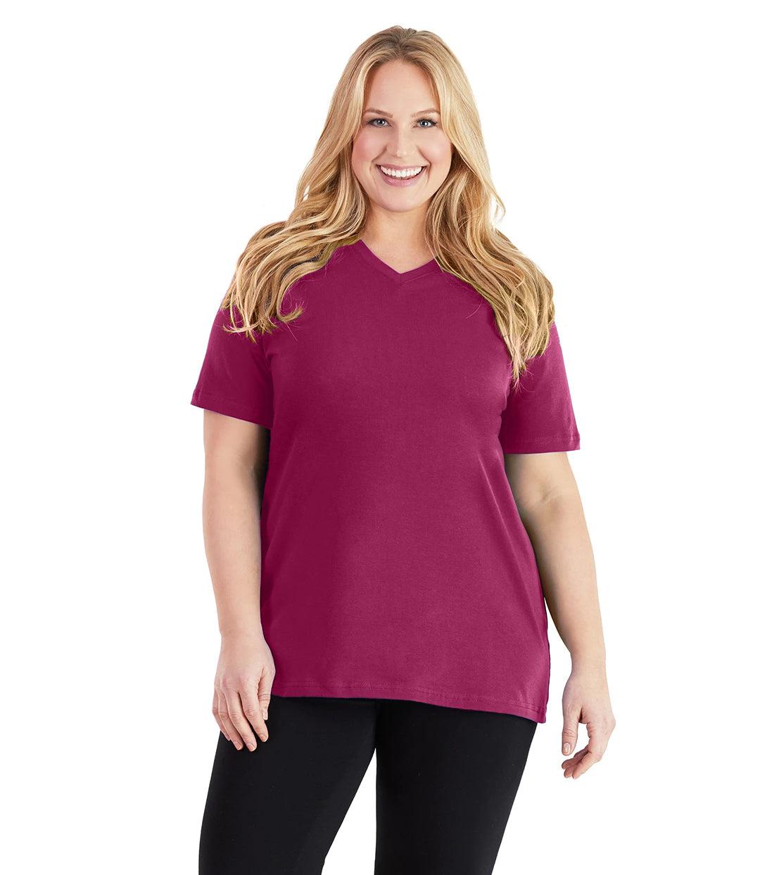 Plus size woman, facing front, wearing JunoActive plus size Stretch Naturals V-Neck in the color Merlot. She is wearing JunoActive Plus Size Leggings in the color black. 