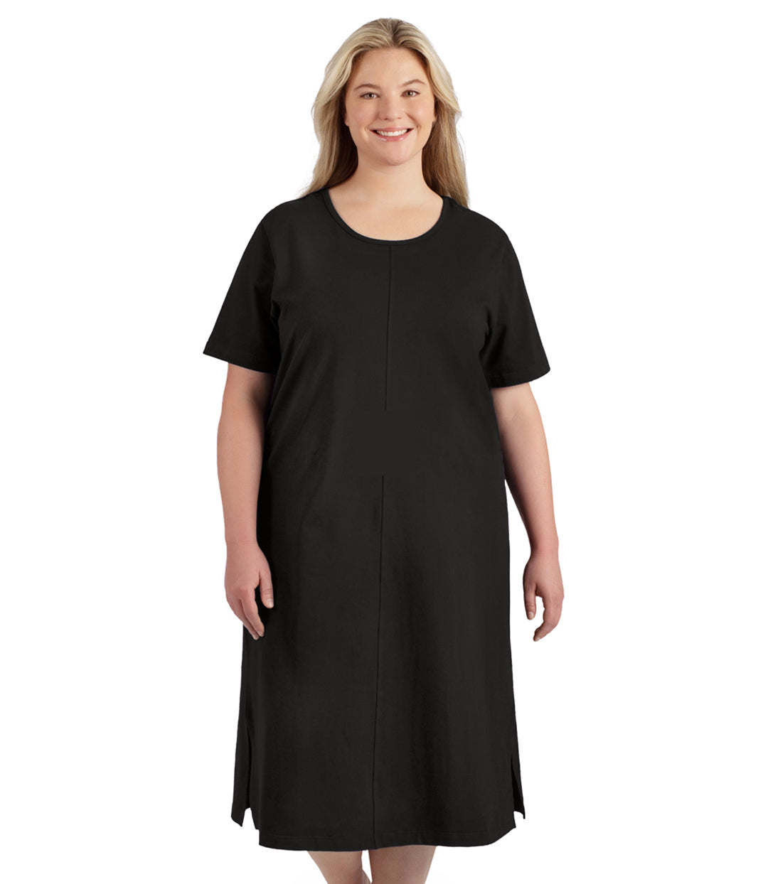 Plus size woman, facing front, wearing JunoActive’s Stretch Naturals Short Sleeve Dress in color black with her hands by her side.