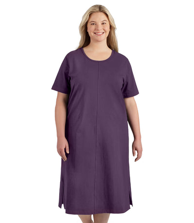 Plus size woman, facing to the front, wearing JunoActive plus size Stretch Naturals Short Sleeve Dress in the color Blackberry. 