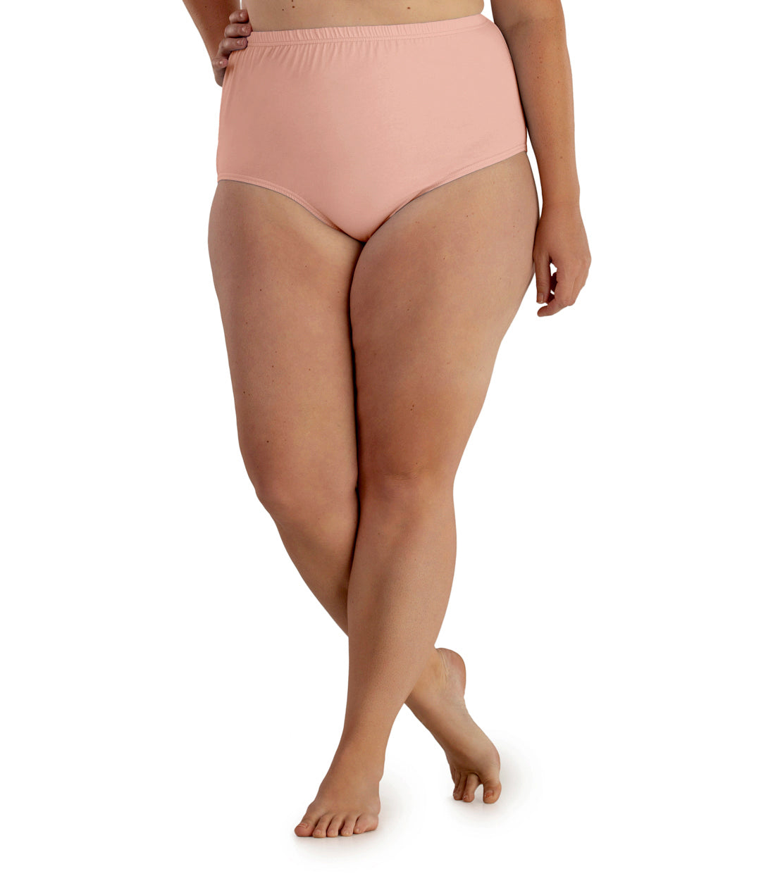 Bottom half of plus sized woman, facing front, wearing JunoActive Junowear Hush Full Fit Briefs in peach. This brief has a high waist fit with conservative leg opening.