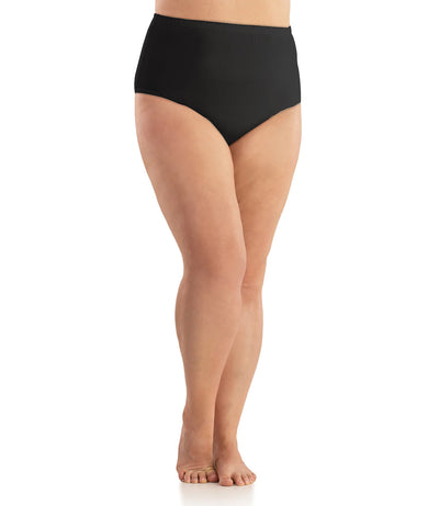 Bottom half of plus sized woman, facing front, wearing JunoActive Junowear Hush Full Fit Briefs in black. This brief has a high waist fit with conservative leg opening.