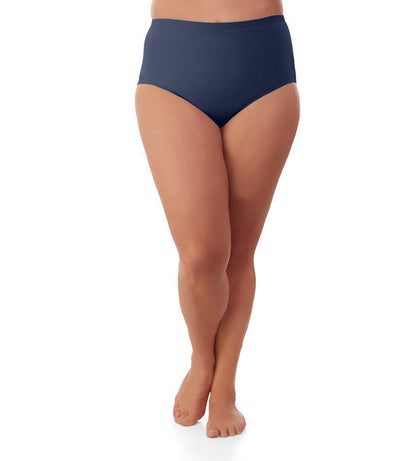 Bottom half of plus sized woman, facing front, wearing JunoActive Junowear Hush Briefs in navy. This brief fits to the waistline with conservative leg opening.