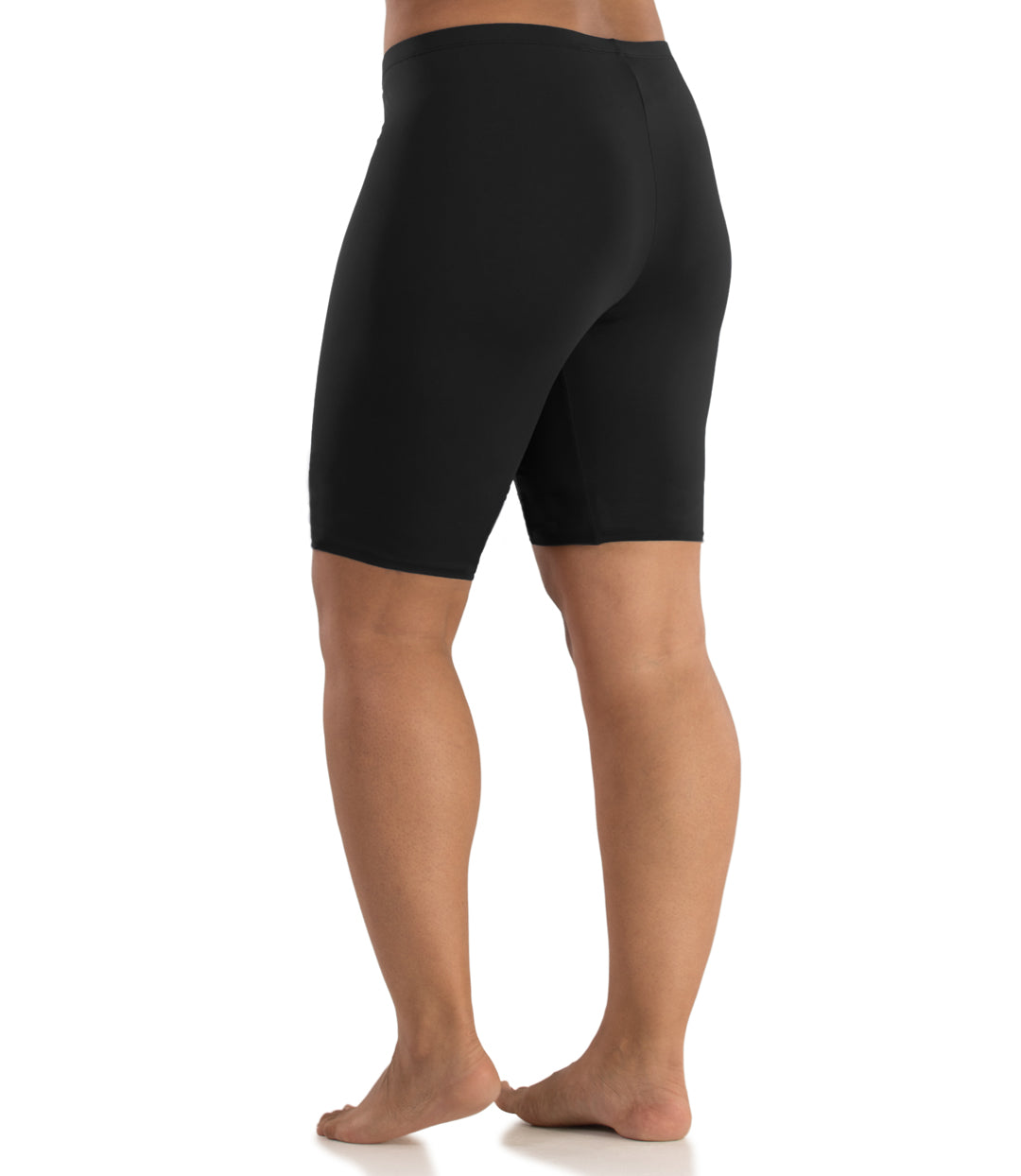 Bottom half of plus sized woman, back view, wearing JunoActive Junowear Hush Long Boxer Brief in black. This fitted boxer fits at the waistline and leg opening is above the knee.