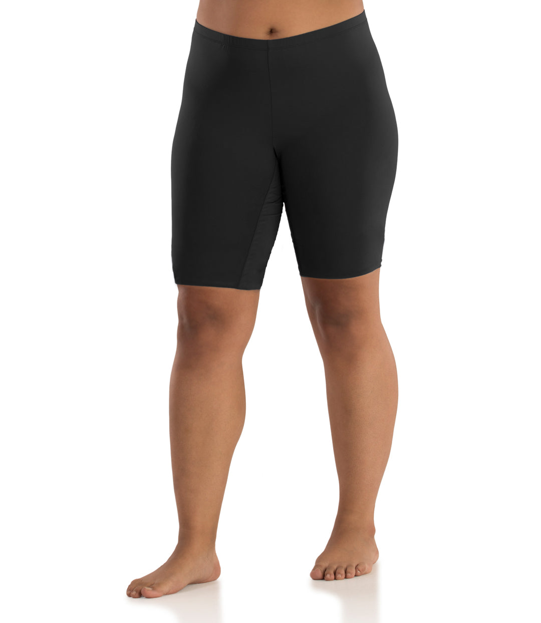 Bottom half of plus sized woman, facing front, wearing JunoActive Junowear Hush Long Boxer Brief in black. This fitted boxer fits at the waistline and leg opening is above the knee.