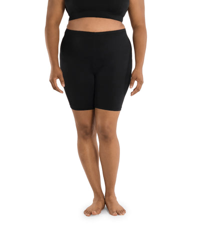 Plus size woman wearing JunoActive's hush full fit boxer in color black. Model is facing forward with hands to her front with hands by her side.