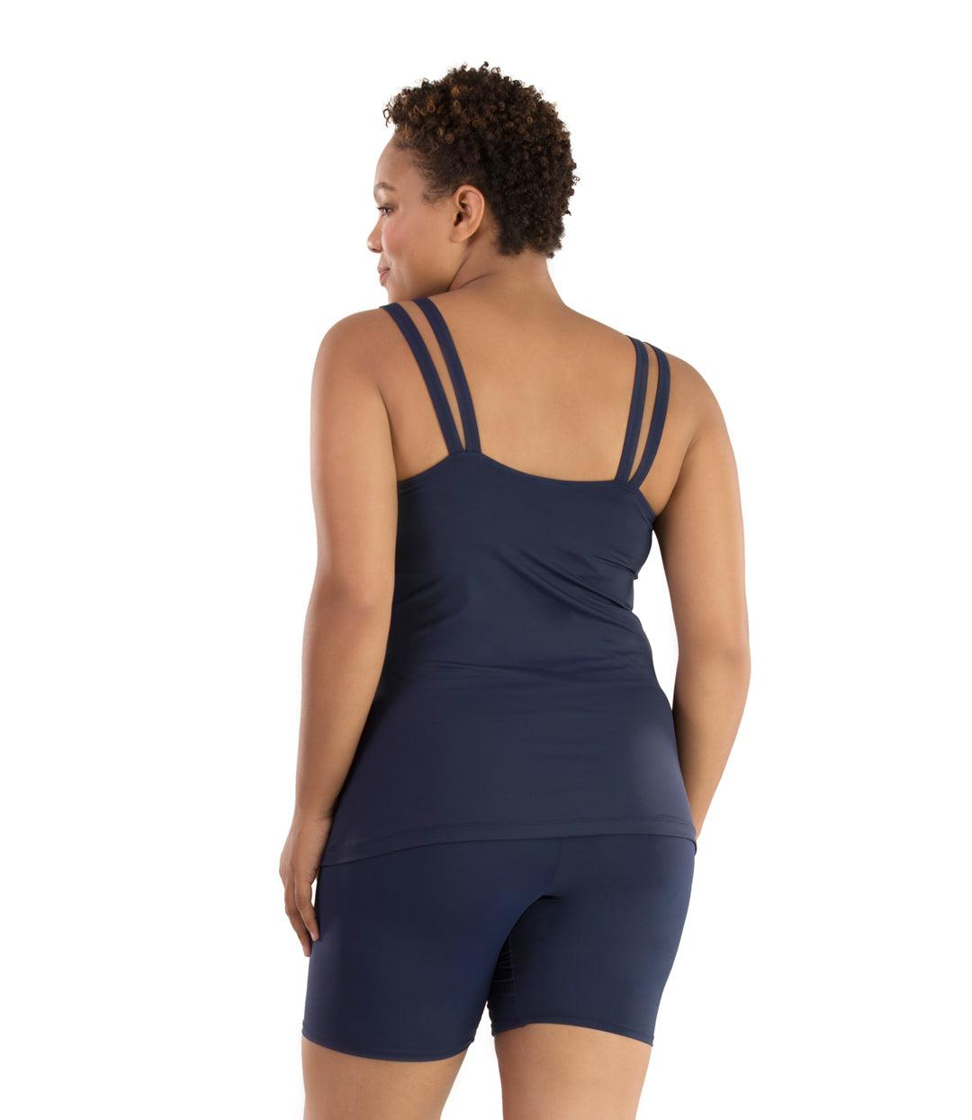 Plus size woman, facing back, wearing JunoActive plus size Junowear Hush Strappy Cami with Bra in Navy Blue. The woman is wearing a pair of Navy Blue Junowear Hush Boxer briefs.
