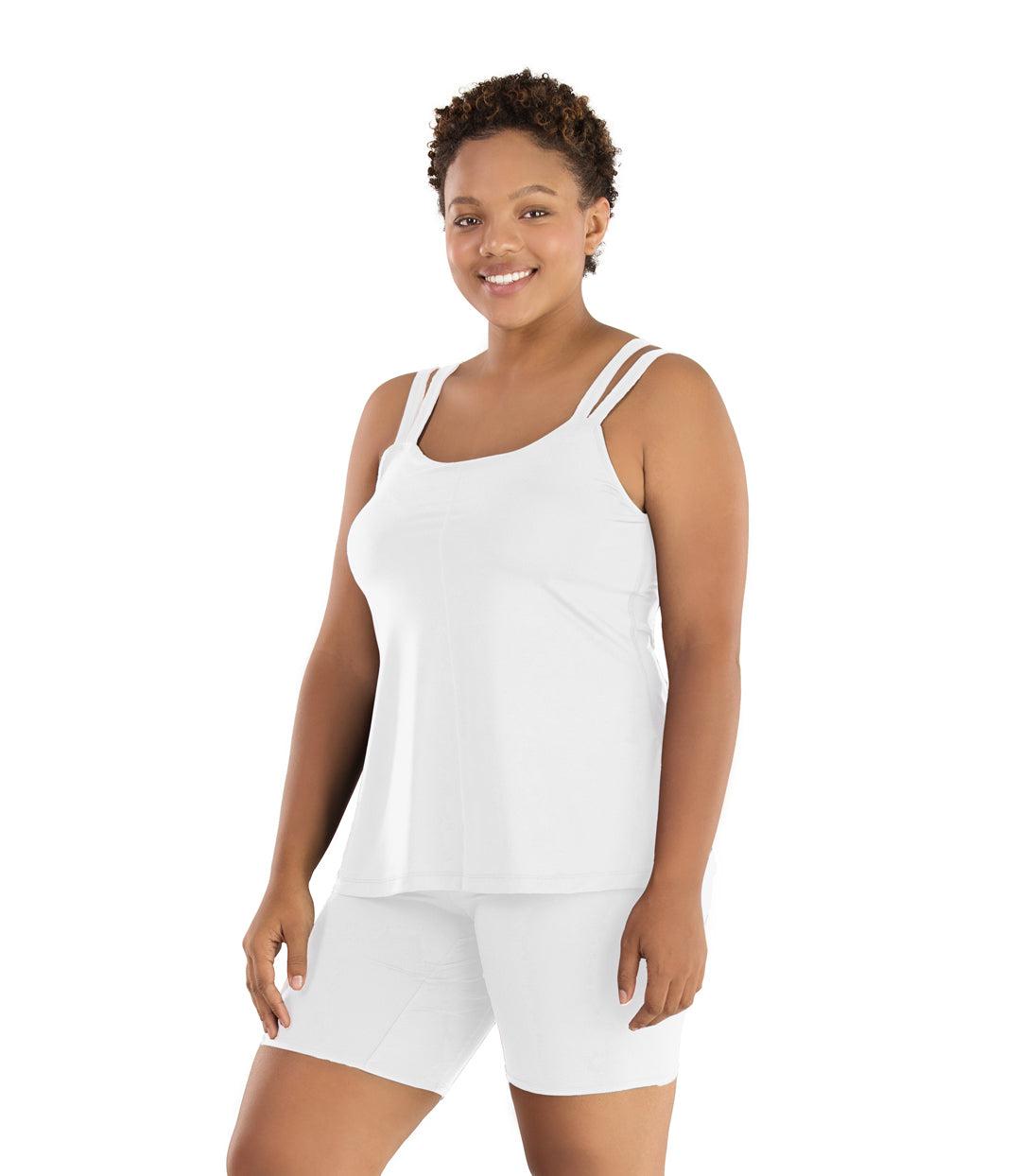 Plus size woman, facing front, wearing JunoActive plus size Junowear Hush Strappy Cami with Bra in White. The woman is wearing a pair of White Junowear Hush Boxer briefs.