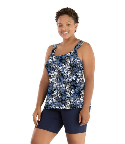 Plus size woman, facing front, wearing JunoActive plus size Junowear Hush Strappy Cami with Bra in Blue Floral Print. The woman is wearing a pair of Navy Blue Junowear Hush Boxer briefs.
