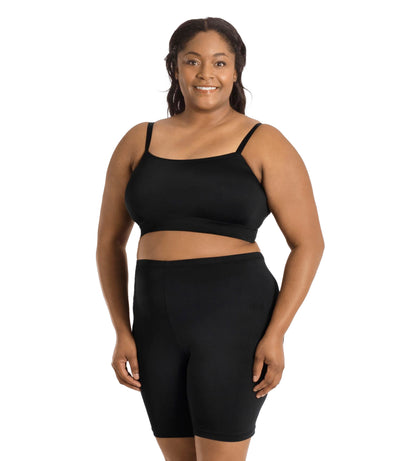 Plus size model wearing JunoActive's Junowear Hush adjustable bralette in color black. Models hands are by her side and she's facing front.