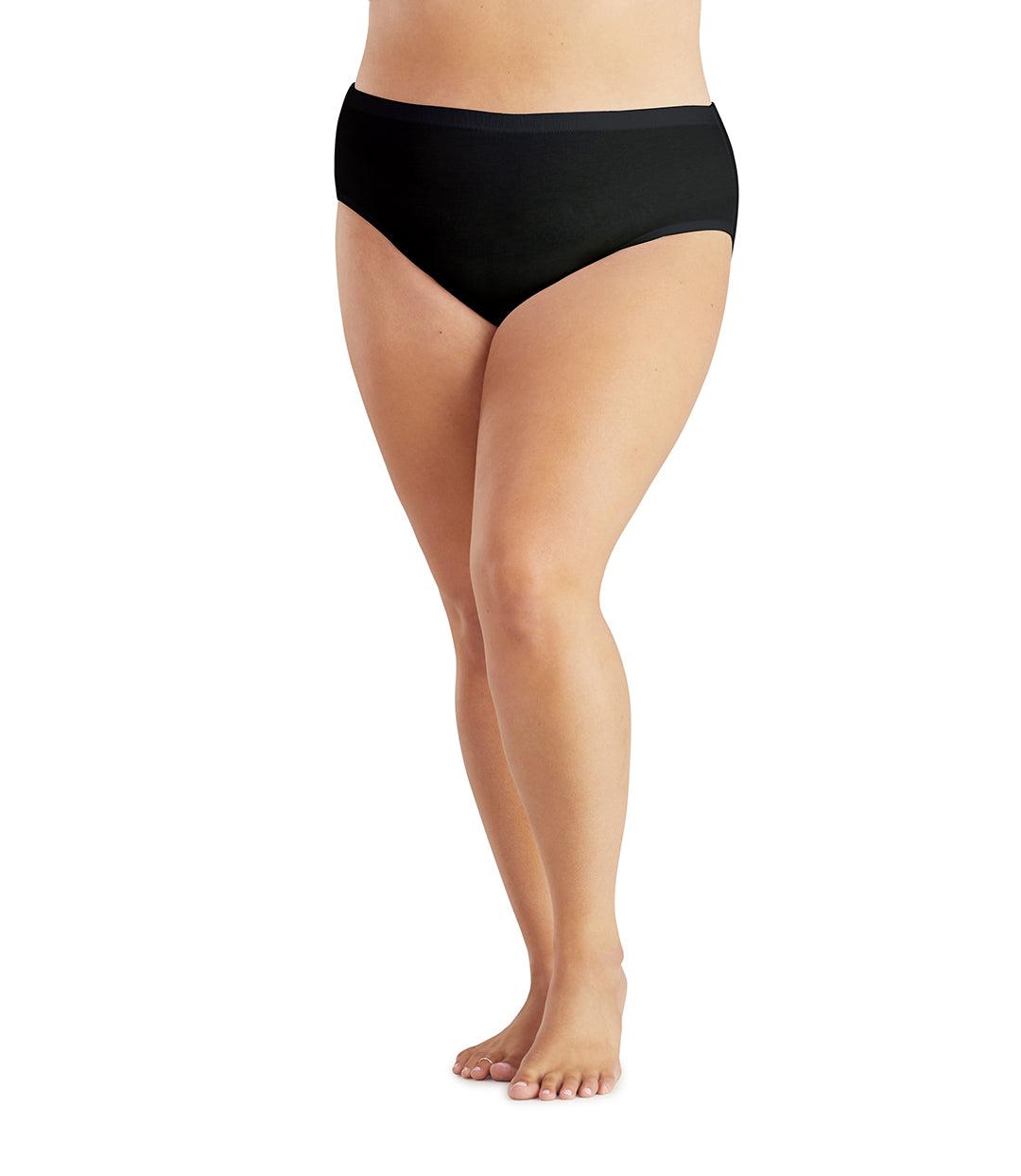 Bottom half of plus sized woman, facing front, wearing JunoActive Junowear Hush Midrise Brief in black. This brief fits a couple inches below the waistline with a conservative leg opening.
